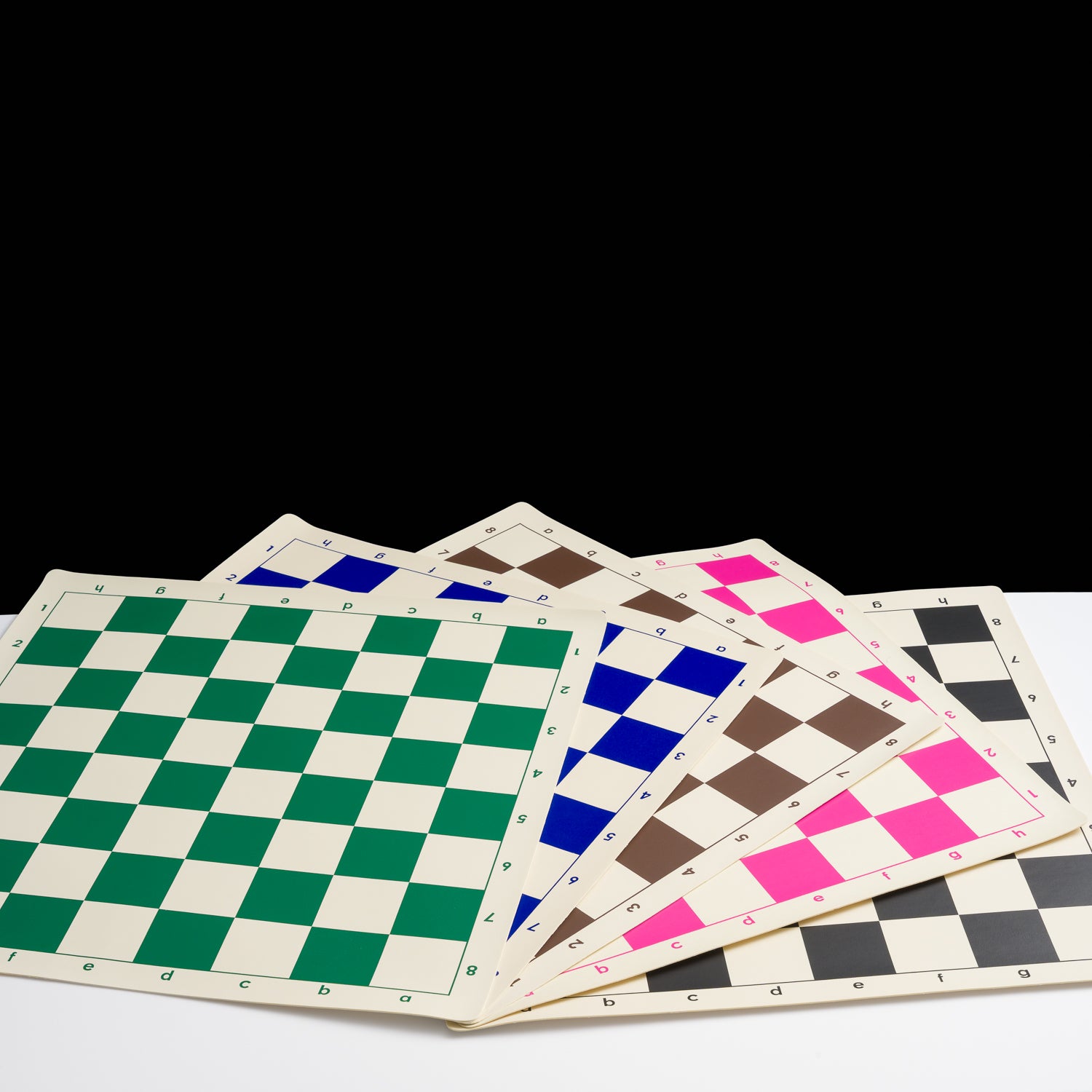 Set of four checkered boards with different color patterns on a white surface.